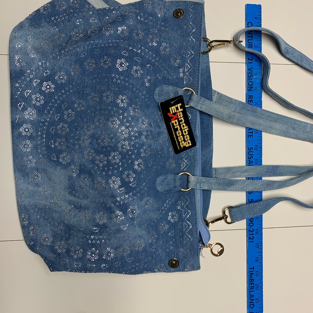 Denim material, long shoulder and two smaller straps. Multiple pockets inside